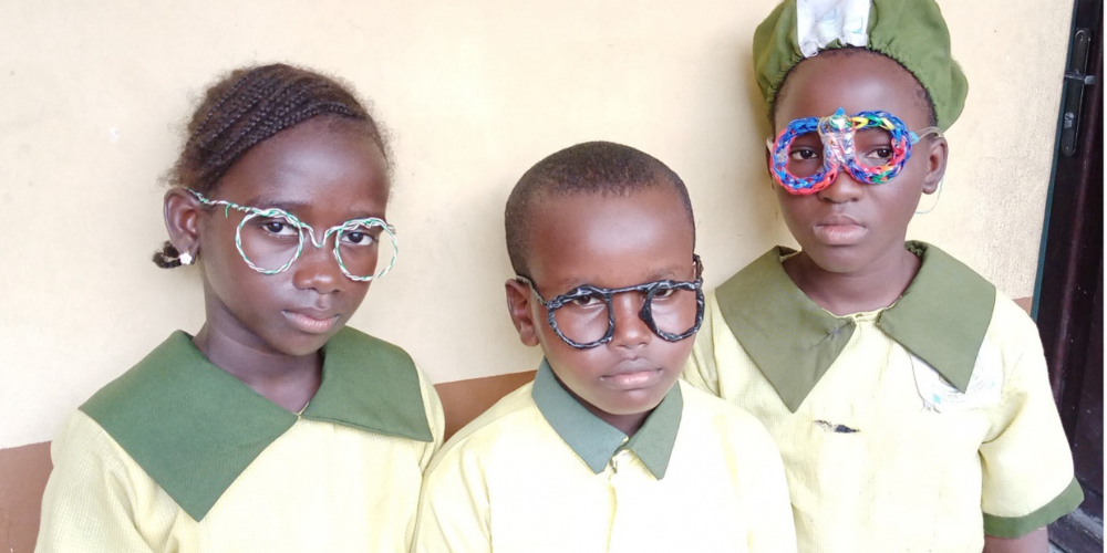 Three school children wearing glasses