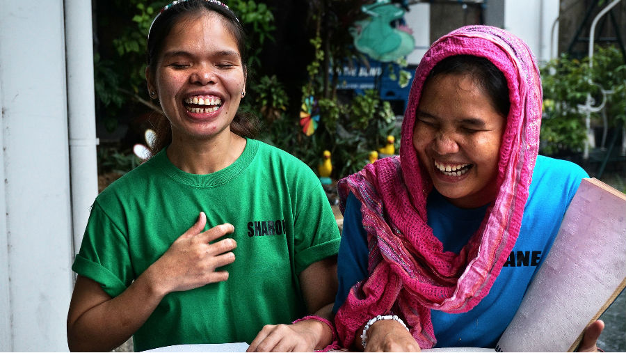 Two girls who are blind reading a braille book/ Story: 2018 in Review: Global Advocacy